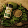 Pahadi Chaat Masala in a bottle and a small bowl, with raw green chilies and mint leaves nearby, emphasizing the contrast between the spice blend and its natural ingredients." Pahadi Chaat Masala in a bottle and a small bowl, with raw green chilies and mint leaves nearby, emphasizing the contrast between the spice blend and its natural ingredients.