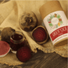 Beetroot powder displayed in a bottle and a bowl, with fresh raw beetroot placed beside them, highlighting the transformation from raw beets to the powdered form