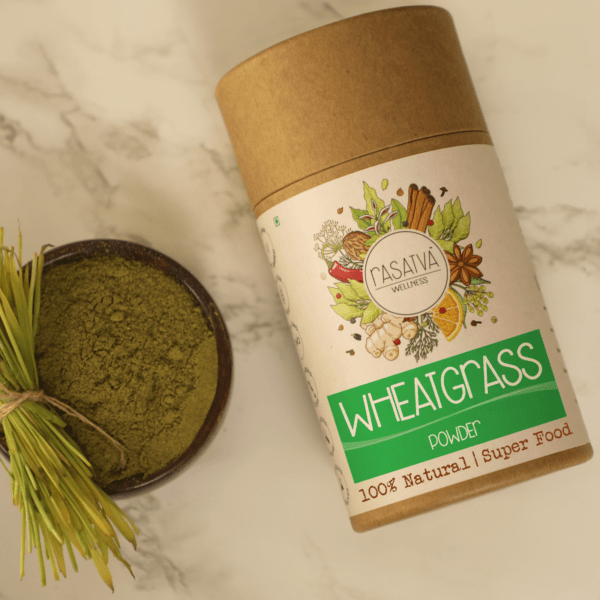 Wheatgrass powder in a clear container, showcasing its vibrant green color and fine texture, with a lid slightly open to reveal the powder inside.