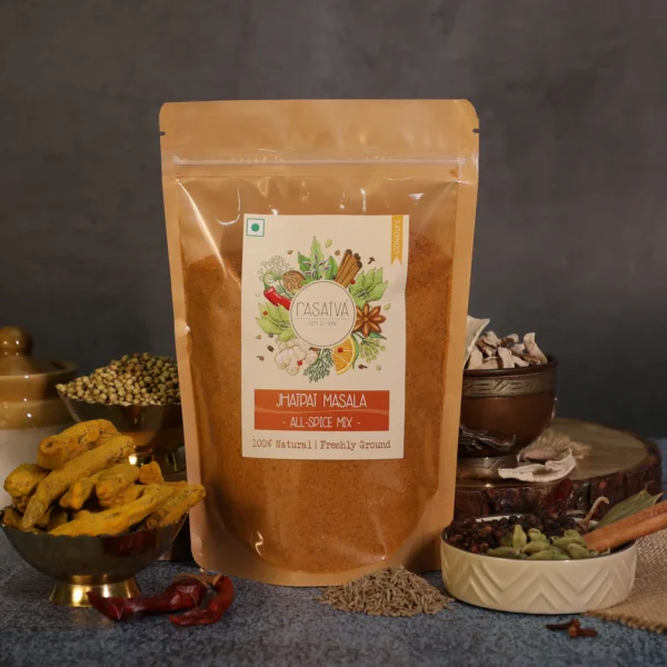 A bag of Rasatva all spice mix powder surrounded by fresh, natural spices on a table, showcasing vibrant flavors and health benefits.