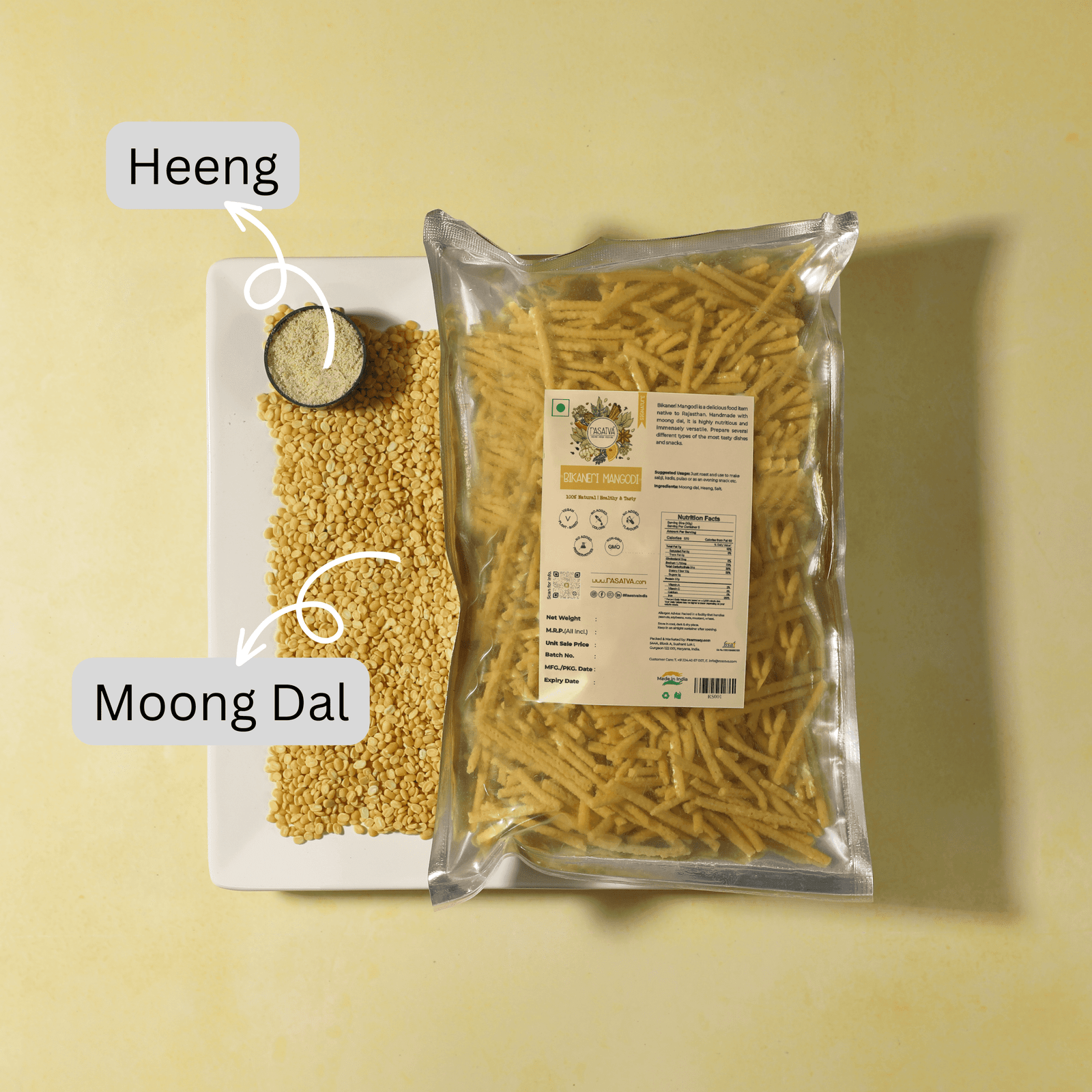 Packet of Bikaneri Mangodi alongside some of the moong dal and hing shown in a bowl, highlighting the product's packaging and its presentation.